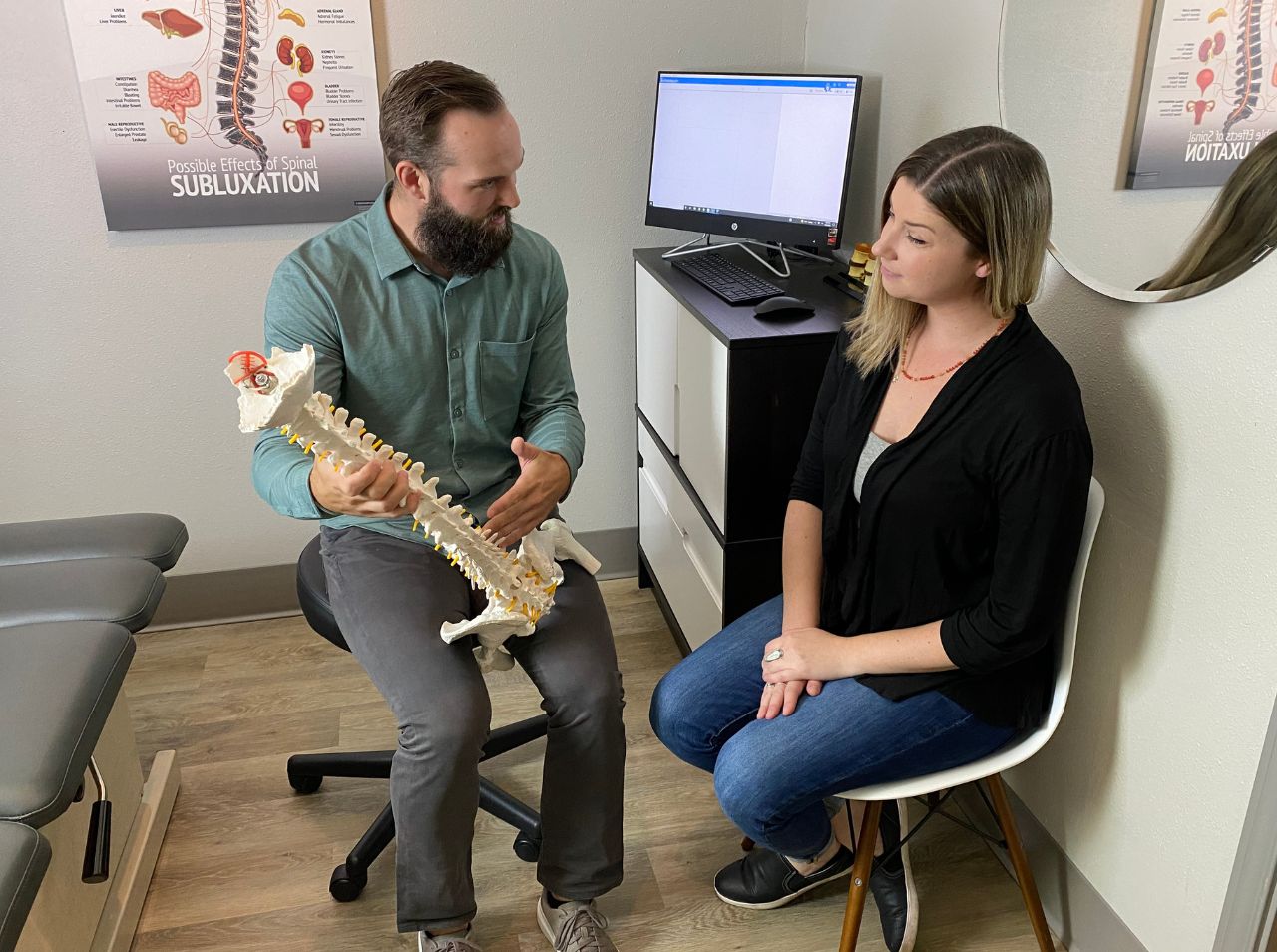 Dr. Walton discussing corrective spinal traction with a female patient