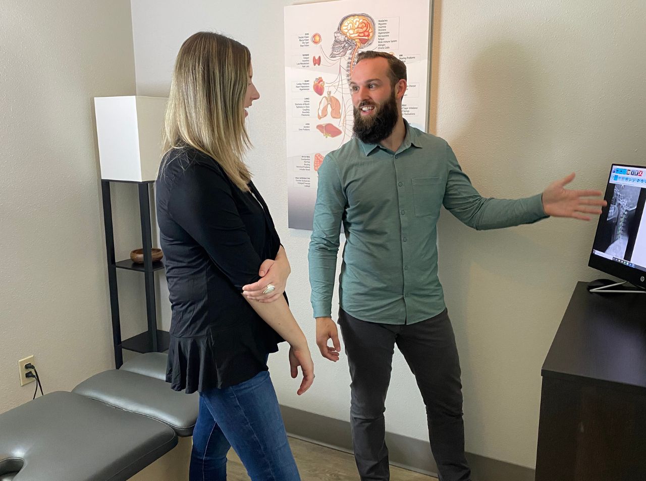 Dr. Walton discussing a chiropractic treatment plan for whiplash injuries with a female patient in Seattle