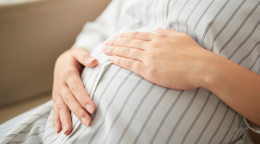 Prenatal Chiropractic Care: Supporting A More Comfortable Pregnancy Through Spinal Alignment 1 women holding her pregnant belly