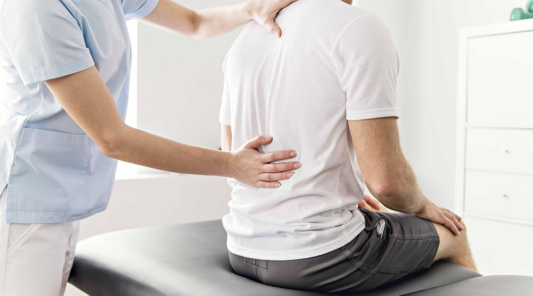 Chiropractor treating patients mid back pain.